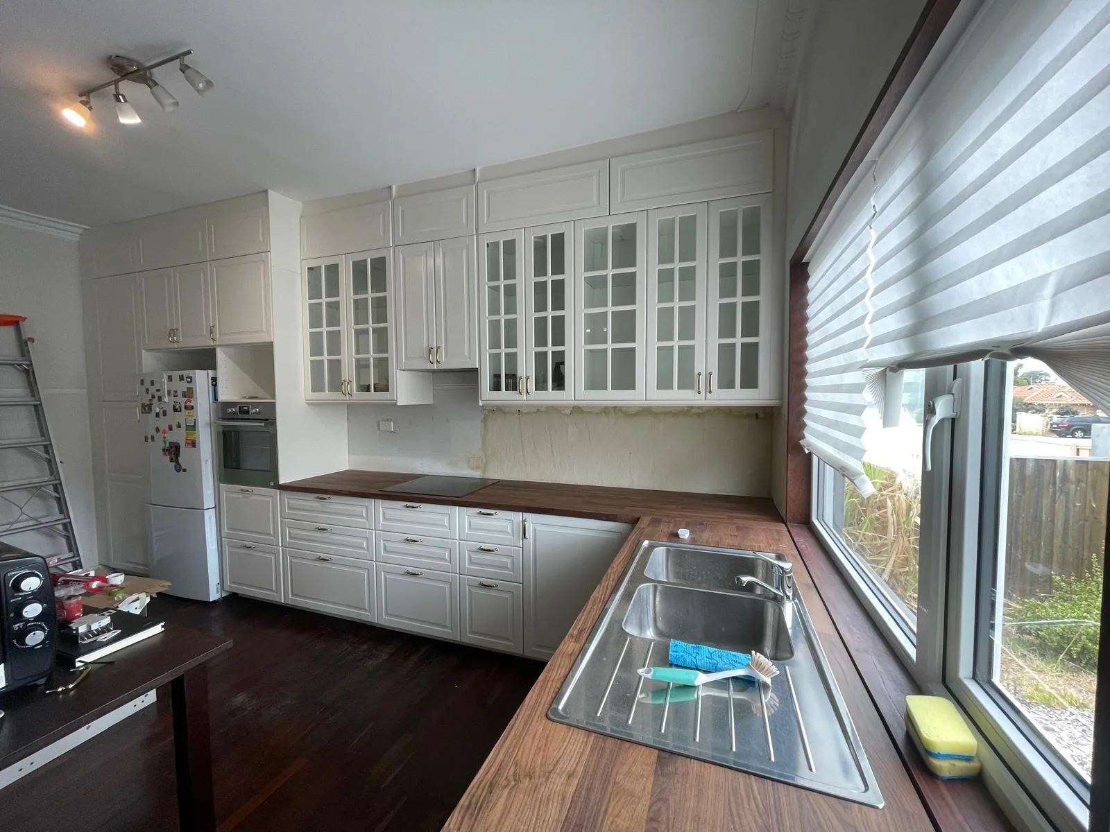 Classic shaker kitchen fit-out with full-height cabinetry and timber benchtops