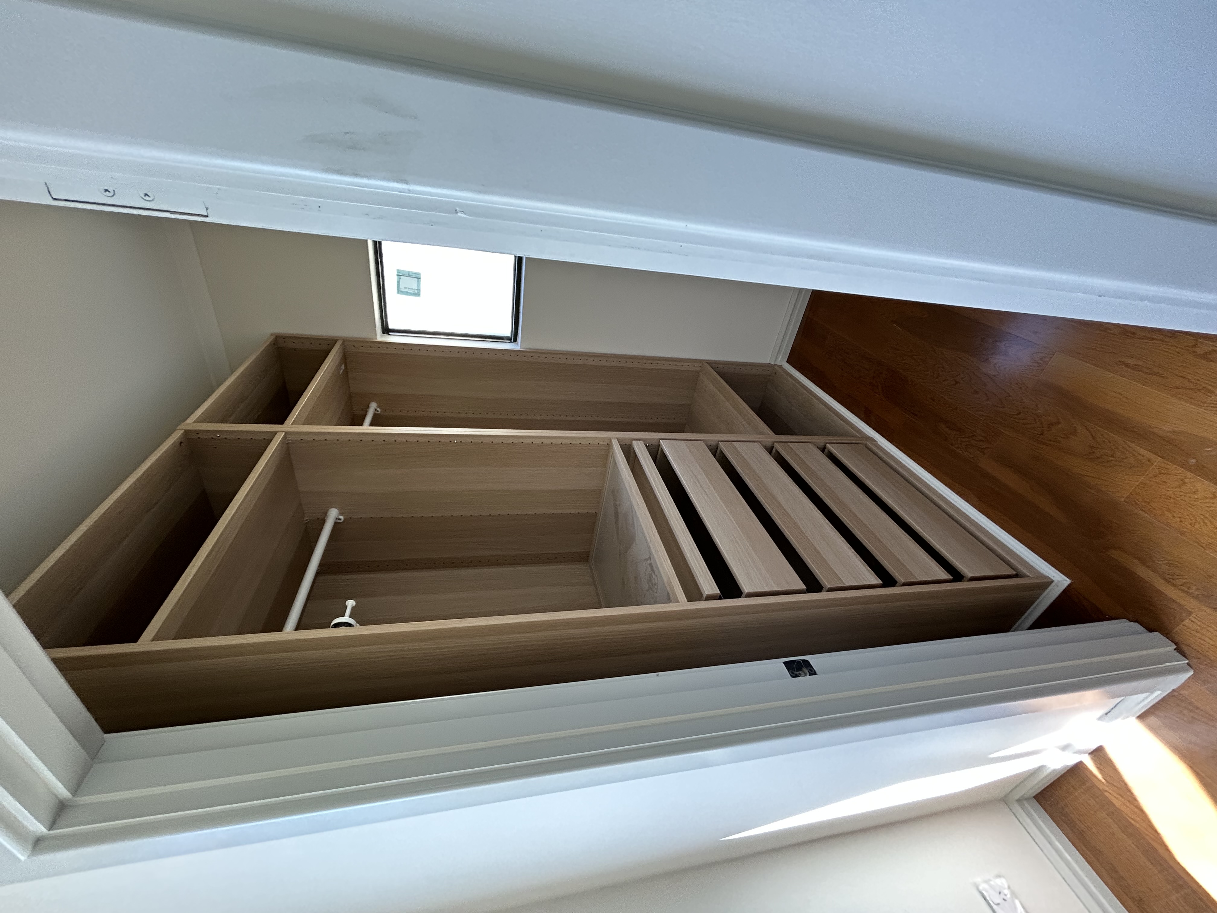 Custom timber walk-in robe joinery with drawers and open hanging storage