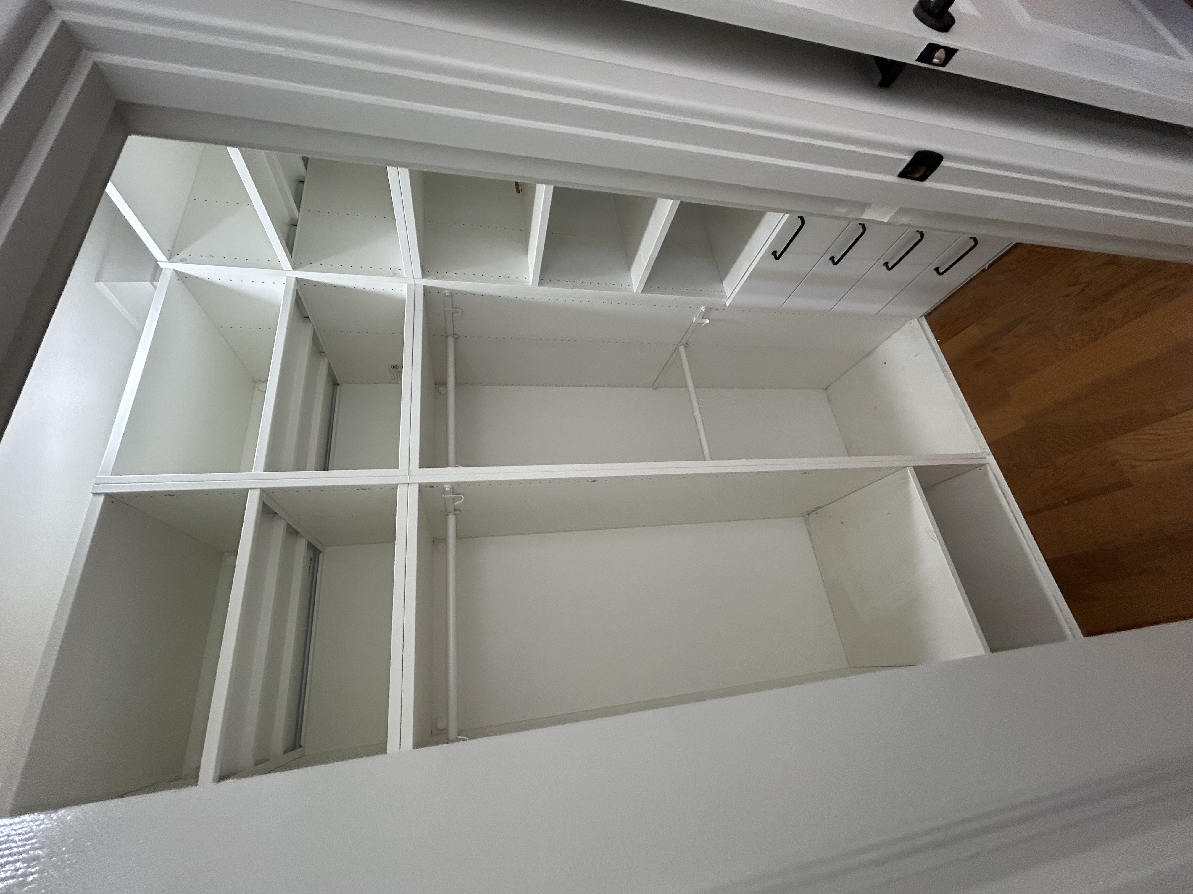 White walk-in robe storage with drawers and shelves